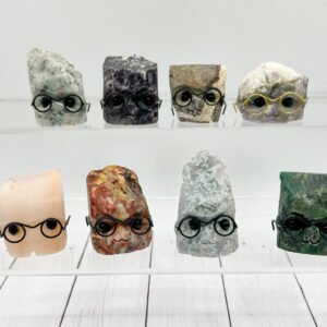 Cute rock characters with glasses on display shelves.