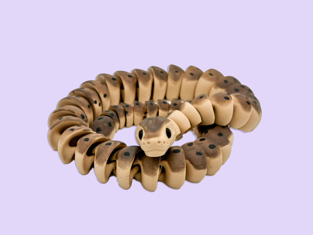 3d printed snake coiled on purple background.